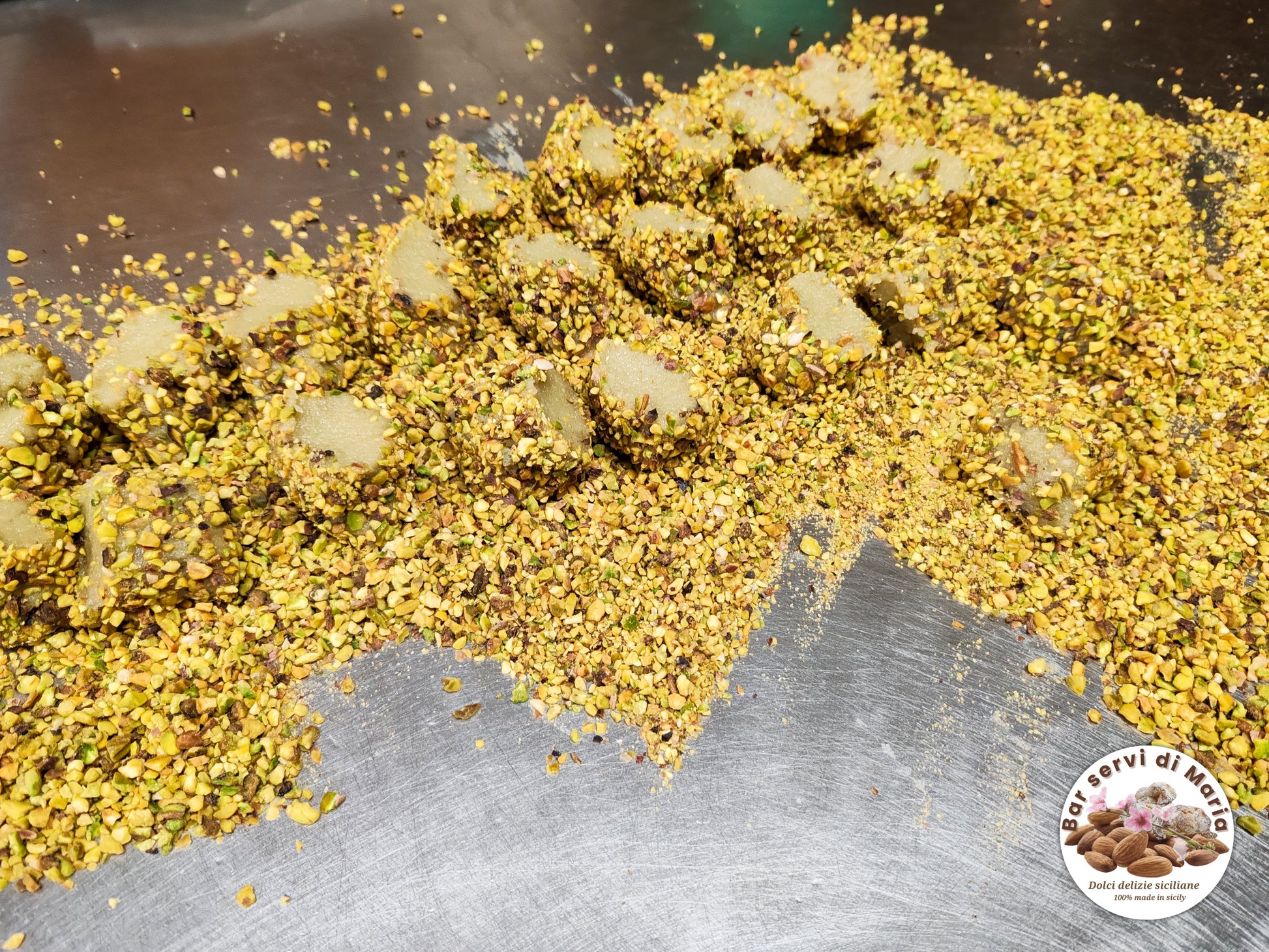 Biscotti pistacchio e mandorle dolci delizie siciliane in fase di preparazione con granella al pistacchio